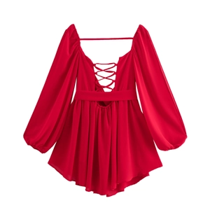 Detail of red V-neck dress featuring open back tie design and airy long puff sleeves