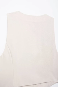 Detailed view of beige linen-blend fabric texture and shoulder seams on women summer vest