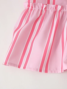 Detail of pink and white striped fabric showing fine pleats and high-quality stitching