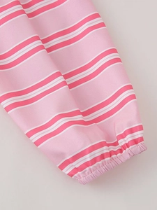 Close-up of pink and white striped shirt cuff with elastic hem and pleated details
