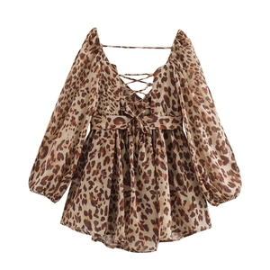 Detail of leopard print dress featuring a square neck and lace-up open back design