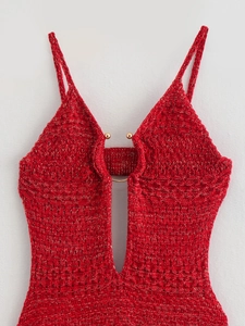 Close-up of red knit dress with gold metallic threads and a metal ring detail