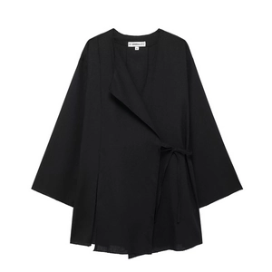 Detailed macro view of black linen blazer with frayed edges and kimono-style tie closure