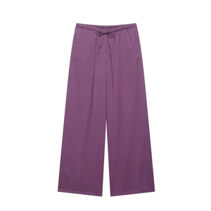 Detail of purple linen wide-leg trousers with elastic drawstring waist and airy fabric