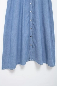 Detail view of denim midi dress with silver buttons and neat stitching lines