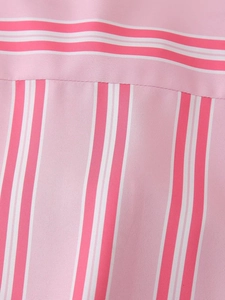 Close-up of pink and white striped shirt fabric showing fine weaving and seam detail