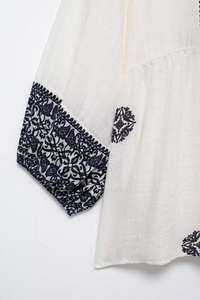 Detail shot of navy blue paisley embroidery and premium cotton-linen fabric texture
