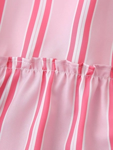 Macro detail of pink and white striped fabric with pleated smocking and neat stitching