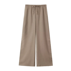 Detail of khaki linen wide-leg trousers with drawstring elastic waistband and soft drape