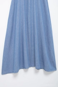 Detail of light blue denim midi dress hem with smooth texture and clean stitching