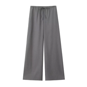 Detail of dark gray linen wide-leg trousers featuring an elastic drawstring waistband