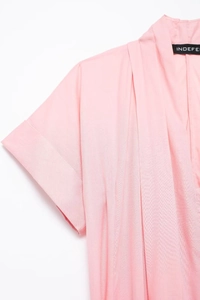 Detail of pink summer shirt dress showing rolled sleeve cuffs and V-neckline texture
