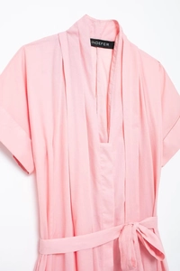 Detailed view of pink shirt dress featuring deep V-neckline with pleated organza accents