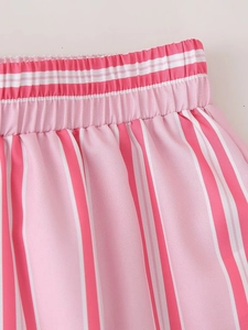 Detail of pink and white vertical striped fabric with an elastic waistband and fine stitching