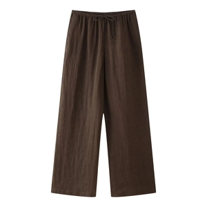 Detail view of deep brown linen wide-leg trousers with elastic waistband and drawstring