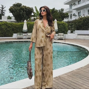 Dettaglio del set beige in jacquard con camicia e pantaloni ampi a fiori eleganti