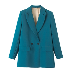 Detailed close-up of a peacock blue blazer showing lapel collar and dark buttons