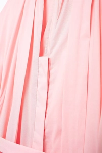 Detail view of pink shirt dress showing fine pleated texture and vertical stitching