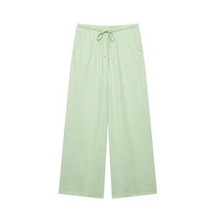 Detail of light green wide-leg trousers with adjustable drawstring elastic waist