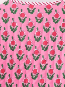 Detail of pink quilted cotton jacket with floral print and red striped piping edge