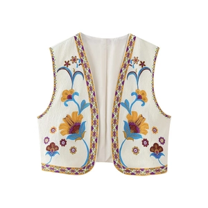 White embroidered ethnic vest with colorful floral patterns and geometric trim accents