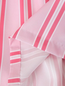 Detailed close-up of pink and white vertical striped fabric with precise stitching