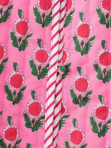 Detail of pink floral quilted jacket with red striped trim and fabric button closure