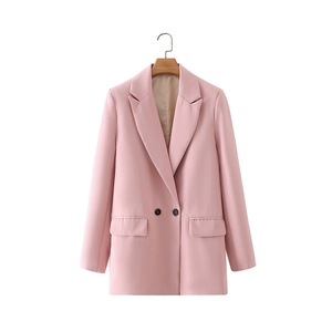 Detail of light pink double-breasted blazer with classic notched lapels and flap pockets