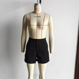 Detail view of black casual cotton shorts with button closure and straight-leg fit