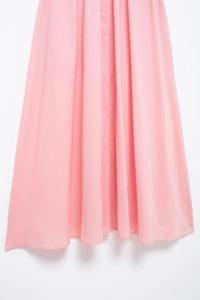 Detailed view of light pink pleated chiffon fabric with clean hem for women dress