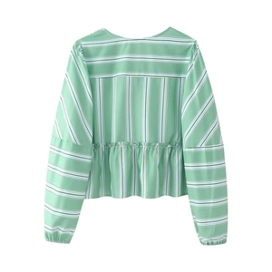 Flat lay of green striped long sleeve peplum top with elastic cuffs and ruffle detail