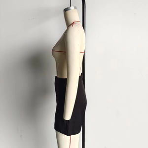 Side view of a black slim-fit mini skirt on mannequin showing the polyester fabric detail