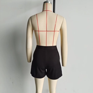 Rear view of black high-waisted shorts on a mannequin showing the sleek tailored fit
