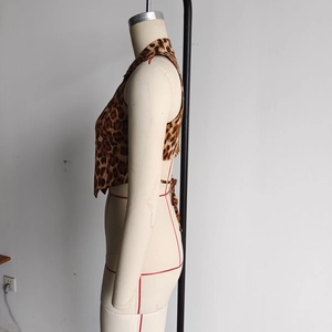 Detail view of leopard print cropped top featuring side slits and tie-back closure