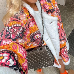 Detail of vintage floral quilted jacket with thick white sherpa lining texture