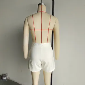 Detail view of white high-waisted shorts featuring a minimalist back profile and slim fit