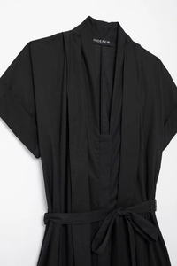 Detail of V-neckline with pleated chest and matching self-tie waist on black dress