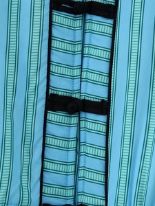 Detail of traditional Chinese knot buttons on a blue striped sleeveless vest