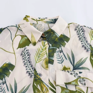 Détail d'une chemise à imprimé végétal tropical avec col à revers et poche décorative