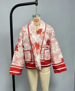 Detailed view of women's red floral quilted jacket with side pockets and red piping trim