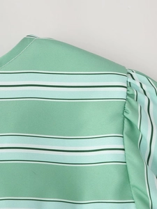 Detail of green striped shirt with puff sleeve shoulder and white neckline stitching