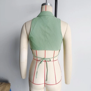 Detail of light green tie-back top showing textured cotton-linen fabric and open back