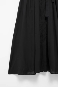 Detailed view of black shirt dress fabric texture with matching waist tie belt