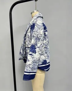 Detail of vintage quilted jacket with blue Toile de Jouy floral and tiger print pattern