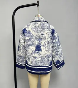 Close-up of quilted jacket featuring blue tiger print and striped ribbed trim
