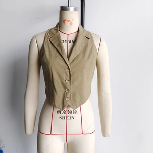 Detail of khaki halter neck vest with single-breasted buttons and classic notched lapel