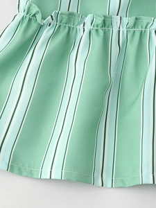 Detail of mint green striped fabric with neat smocking technique and fine vertical texture