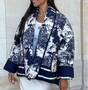 Detail of women's quilted jacket featuring blue toile de jouy pattern and large collar