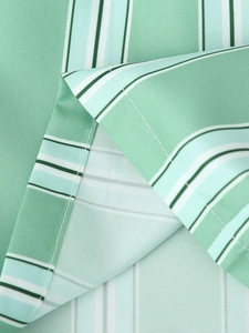 Detail of mint green and white vertical stripe fabric with precise stitching edges