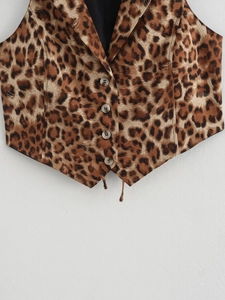 Detail showing leopard print waistcoat with lapel collar and four buttons on beige background